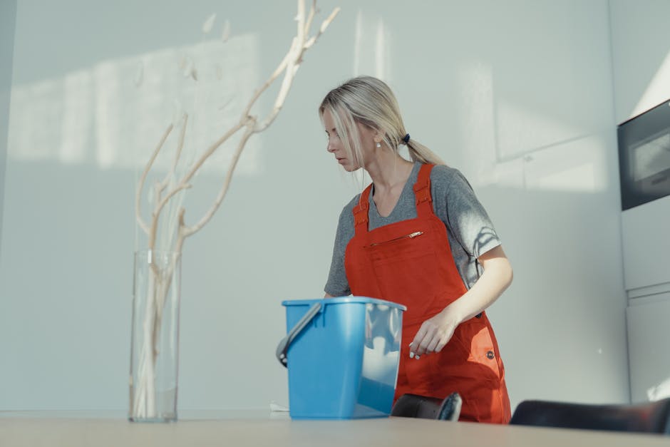 Happy professional cleaner providing maid service